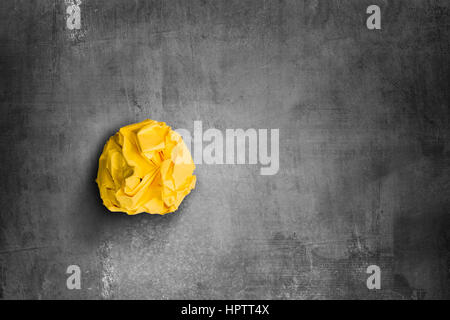 crumpled yellow paper ball Stock Photo