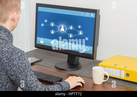 man using social network on computer Stock Photo