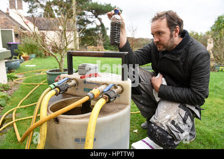 Heating engineer plumber power flushing a domestic central heating system Stock Photo