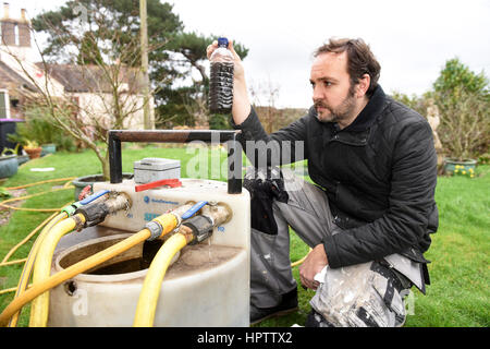 Heating engineer plumber power flushing a domestic central heating system Stock Photo