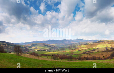 Spring sunny morning in the Alps with bright sun shines over hills Stock Photo