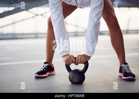 Closeup of woman holding kettlebell before swing exercise Stock Photo