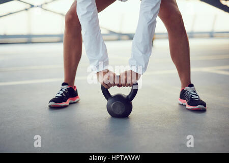 Swing exercise closeup - woman holding kettlebell weight Stock Photo