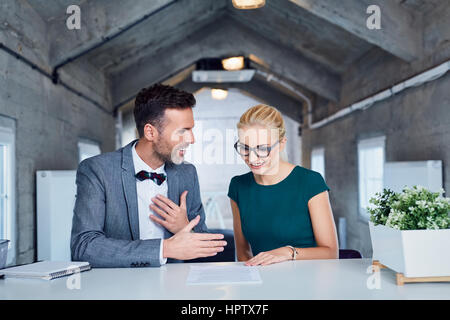young business managers analyze document in modern office. Stock Photo