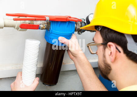 water filtration - plumber changing dirty water filter Stock Photo