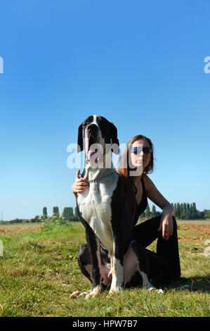 Beautiful young woman with a great dane Stock Photo