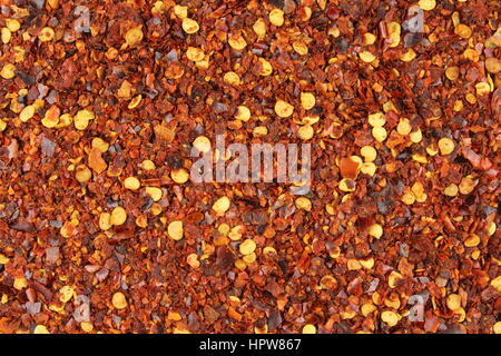 crushed red pepper flakes closeup as a food background texture Stock Photo
