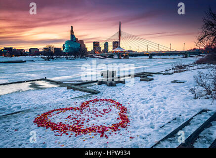 Winnipeg, Illuminated Provencher Bridge over frozen Red river in the night. Stock Photo