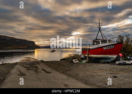 View looking west north west from Stein Slipway, Isle of Skye, with the approaching October sunset, reflecting off the clouds. Stock Photo