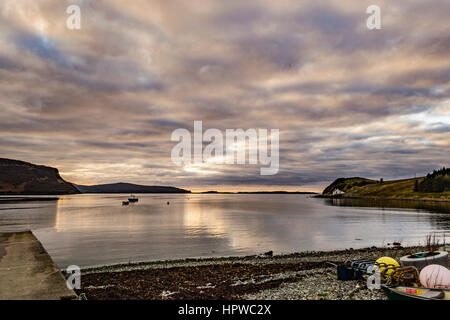 View looking west north west from Stein Slipway, Isle of Skye, with the approaching October sunset, reflecting off the clouds. Stock Photo