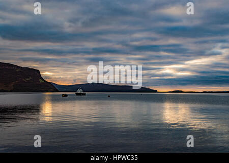 View looking west north west from Stein Slipway, Isle of Skye, with the approaching October sunset, reflecting off the clouds. Stock Photo