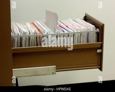 Metal File Cabinet with Hanging File Folders Stock Photo