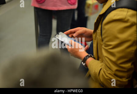 People using cellphone while travelling Stock Photo