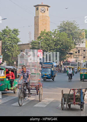 An unidentified bicycle porter taking a high load through the busy early morning streets of Ahmedabad, a common sight in Indian towns and cities Stock Photo