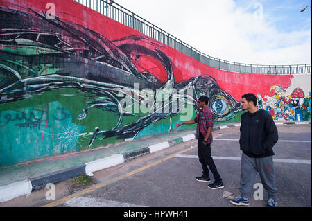 Libya, Tripoli: After Gadaffi's death quite a few graffiti artists began spraying their murals on public walls. Stock Photo
