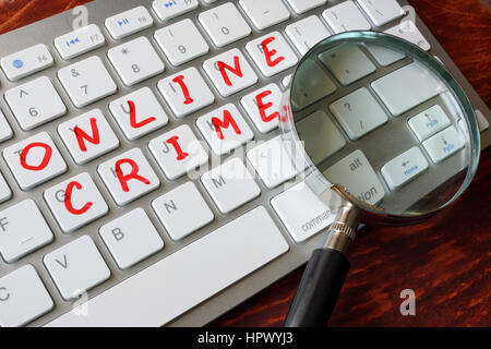 Online crime written on a keyboard. Stock Photo