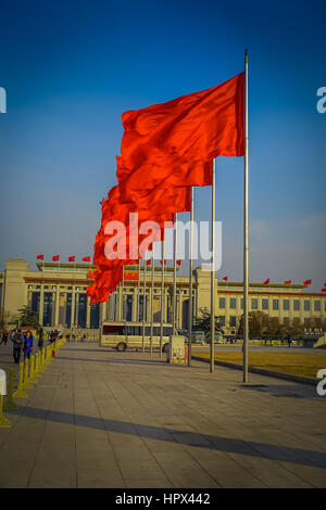 BEIJING, CHINA - 29 JANUARY, 2017: Great hall of the people, spectacular building located on Tianmen square, many red flags, beautiful blue sky. Stock Photo