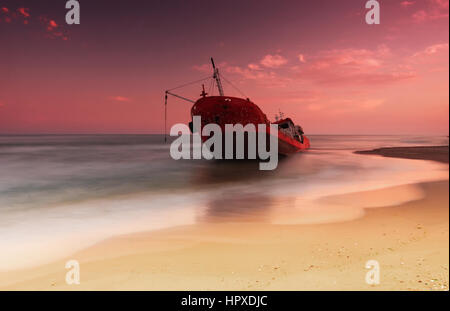 Ship after wreck on the coast with smooth water Stock Photo