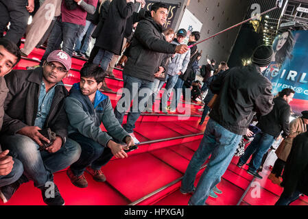 tourists posing for selfies on the red steps in times square, new york ...