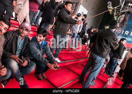 tourists posing for selfies on the red steps in times square, new york ...