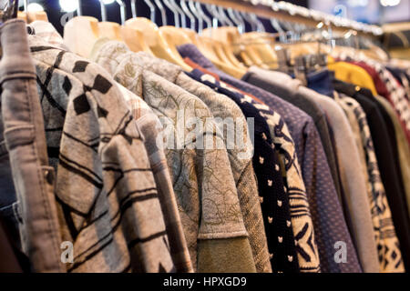 View perspective of warm clothing on hangers. MOMAD International fashion trade show IFEMA 2017. Madrid (Spain). Stock Photo