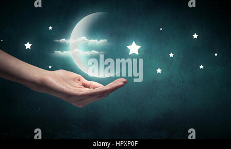 Human hand holding moon planet in palm Stock Photo