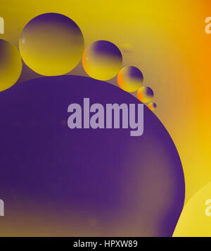 Abstract picture of round oil drops in water. Macro shot of colored bubbles. Stock Photo