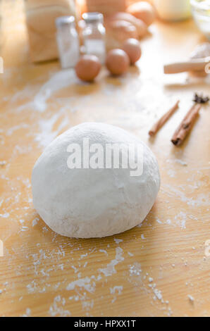 Close up shot of dough with bakery ingredients on wooden table Stock Photo