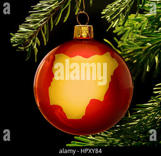 A red bauble with the golden shape of  Nigeria hanging on a christmas tree isolated on black.(series) Stock Photo