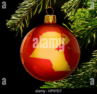 A red bauble with the golden shape of  Kuwait hanging on a christmas tree isolated on black.(series) Stock Photo