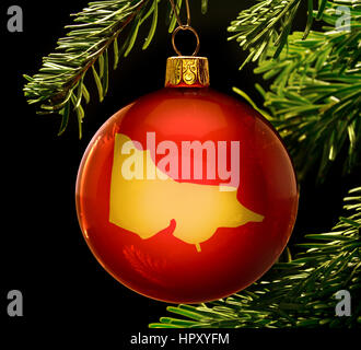 A red bauble with the golden shape of  Victoria hanging on a christmas tree isolated on black.(series) Stock Photo
