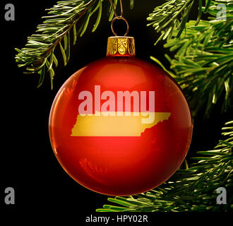 A red bauble with the golden shape of  Tennessee hanging on a christmas tree isolated on black.(series) Stock Photo