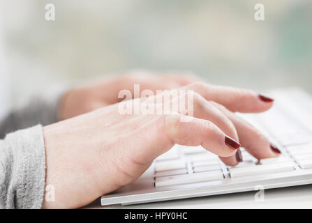 Female hands or woman office worker typing on the keyboard Stock Photo