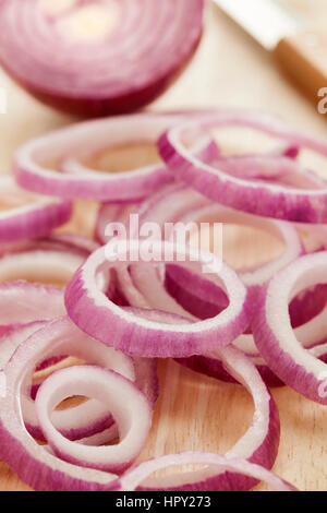 Fresh cut raw red onion rings on the table Stock Photo