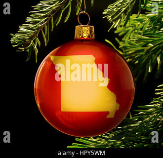 A red bauble with the golden shape of  Missouri hanging on a christmas tree isolated on black.(series) Stock Photo