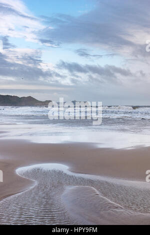 Beach at Cayton bay near Scarborough, North Yorkshire, ENgland. View towards Knipe point and Scarborough castle. Stock Photo