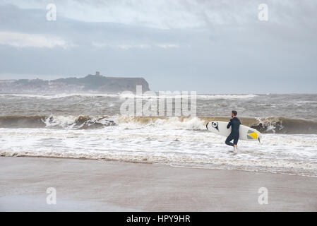 Surfer on the beach at Cayton bay near SCarborough, North Yorkshire, England. Stock Photo