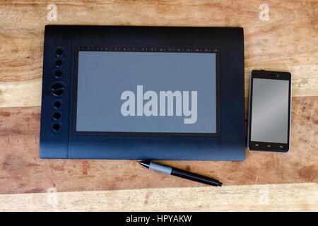 drawing tablet and moblie on the wood table Stock Photo