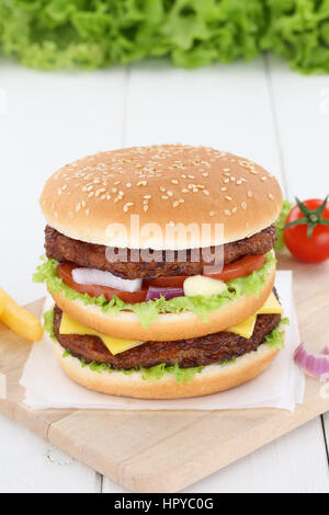 Double burger hamburger fresh beef tomatoes lettuce cheese unhealthy Stock Photo