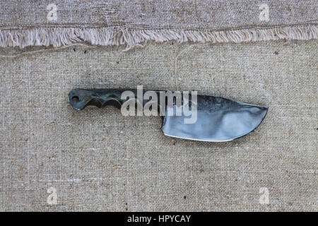 Knife for field kitchen. Knife on the background fabric from flax. Stock Photo
