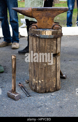 Forging iron on the street. Manufacturing of the knife. Stock Photo