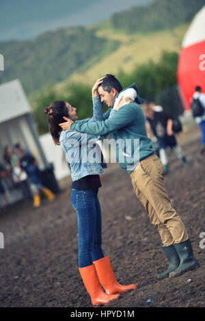 BONTIDA, ROMANIA - JULY 16, 2016: People living heavy rainy days at Electric Castle Festival. After 3 days of raining the area of the festival became  Stock Photo