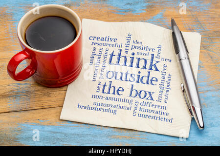 Think outside the box word cloud - handwriting on a napkin with a cup of coffee Stock Photo
