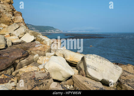 View from Knipe point (Osgodby point) near Scarborough on the coast of North Yorkshire, England. A beautiful sunny day on the rocky headland. Stock Photo