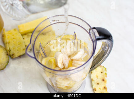 Sliced pineapple and banana in a blender Stock Photo
