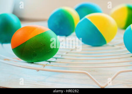 Easter eggs painted by hand yellow and blue lie on lattice Stock Photo
