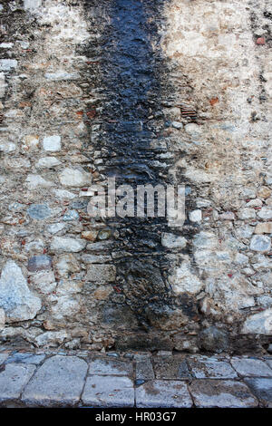 Background medieval stone wall with traces of weathering from leaking water Stock Photo