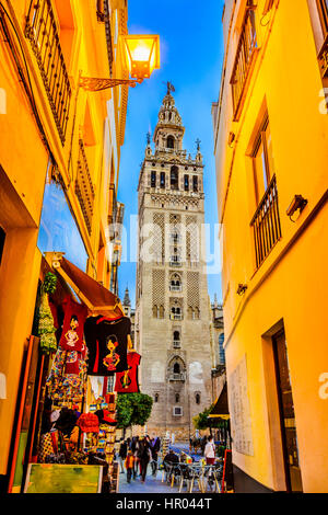 Street view of the Giralda tower, famous bell tower of the Cathedral of Seville, Andalusia, Spain Stock Photo