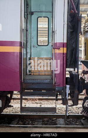 Open the door of the old carriage on the platform. Train ready to leave stands at the railway station. Stock Photo