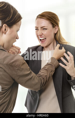 two business woman mad and fighting each other Stock Photo